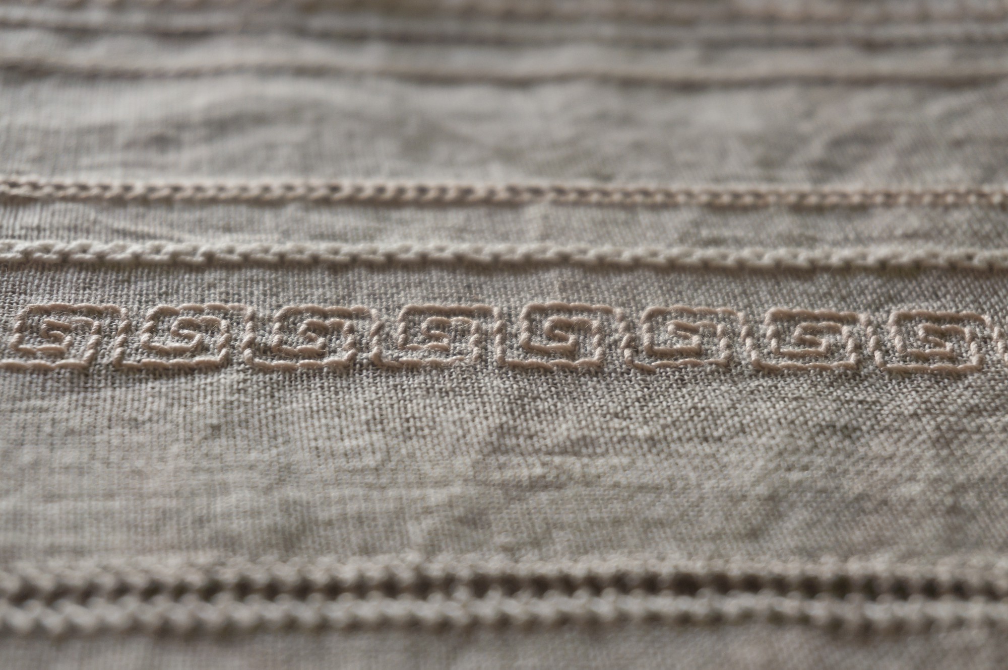 close-up of bold embroidered stitches on linen